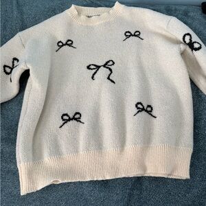 Cream Sweater with Black Bow Accents